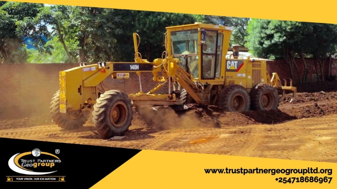 Heavy earthworks equipment in operation on a construction site in [Nairobi/Machakos/Kiambu/Nakuru], including excavators and dump trucks, performing trenching and grading with on-site safety measures