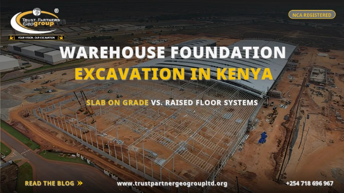 TRUST PARTNERS GEO-GROUP blog poster on warehouse foundation excavation in Kenya — aerial view of a large warehouse under construction with steel frame and partial roofing, comparing slab on grade vs. raised floor systems at trustpartnergeogroupltd.org